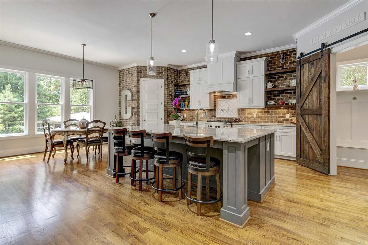 Kitchen with brick surround, granite island and barn door
