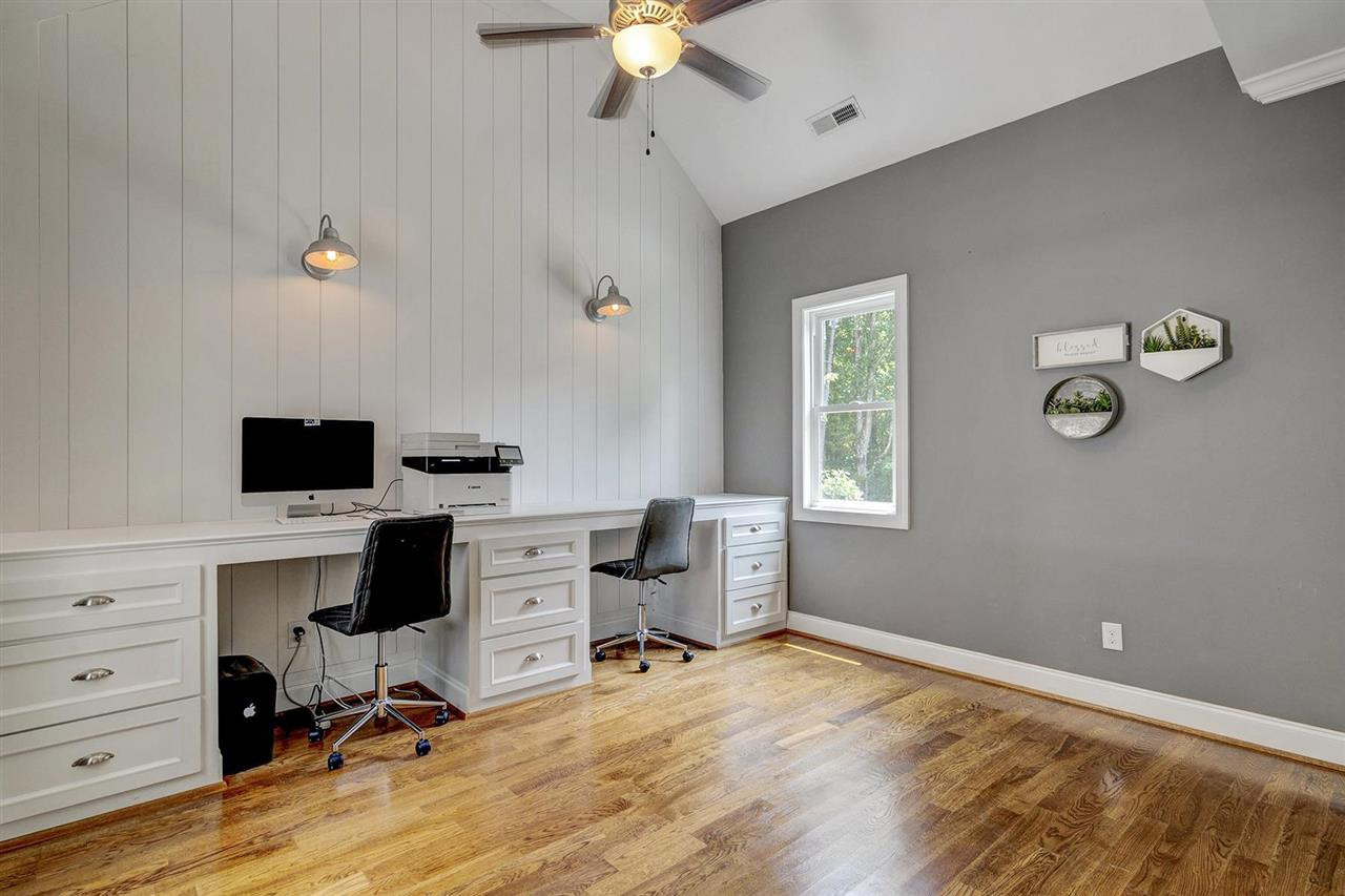 Built-in home office with shiplap and vaulted ceiling